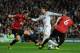 MADRID, SPAIN - FEBRUARY 13: Cristiano Ronaldo of Real Madrid is put under pressure by Jonny Evans and Phil Jones of Manchester United during the UEFA Champions League Round of 16 first leg match between Real Madrid and Manchester United at Estadio Sant