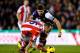STOKE ON TRENT, ENGLAND - JANUARY 12: Charlie Adam of Stoke City battles with Steven Gerrard of Liverpool during the Barclays Premier League match between Stoke City and Liverpool at Britannia Stadium on January 12, 2014 in Stoke on Trent, England. (Pho