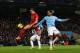 MANCHESTER, ENGLAND - DECEMBER 26: Jordan Henderson of Liverpool is challenged by Joleon Lescott of Manchester City as he shoots from close range during the Barclays Premier League match between Manchester City and Liverpool at Etihad Stadium on December