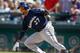 SEATTLE, WA - AUGUST 11: Carlos Gomez #27 of the Milwaukee Brewers grounds out for the final out against the Seattle Mariners at Safeco Field on August 11, 2013 in Seattle, Washington. The Mariners defeated the Brewers 2-0. (Photo by Otto Greule Jr/Gett