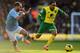 NORWICH, ENGLAND - FEBRUARY 08: Nathan Redmond (R) of Norwich City holds off the challenge of Pablo Zabaleta (L) of Manchester City during the Barclays Premier League match between Norwich City and Manchester City at Carrow Road on February 8, 2014 in No