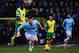 NORWICH, ENGLAND - FEBRUARY 08: Alexander Tettey of Norwich City tackles Aleksandar Kolarov of Manchester City from behind during the Barclays Premier League match between Norwich City and Manchester City at Carrow Road on February 8, 2014 in Norwich, En