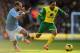 NORWICH, ENGLAND - FEBRUARY 08: Nathan Redmond (R) of Norwich City holds off the challenge of Pablo Zabaleta (L) of Manchester City during the Barclays Premier League match between Norwich City and Manchester City at Carrow Road on February 8, 2014 in No