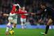 LONDON, ENGLAND - FEBRUARY 02: Mesut Ozil of Arsenal has his shirt pulled by Marouane Chamakh of Crystal Palace during the Barclays Premier League match between Arsenal and Crystal Palace at Emirates Stadium on February 2, 2014 in London, England. (Phot