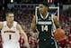 Feb 9, 2014; Madison, WI, USA; Michigan State Spartans guard Gary Harris (14) dribbles the ball as Wisconsin Badgers guard Ben Brust (1) chases at the Kohl Center. The Badgers won 60-58. Mandatory Credit: Mary Langenfeld-USA TODAY Sports