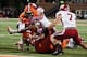 Oct 19, 2013; Champaign, IL, USA; Illinois Fighting Illini quarterback Aaron Bailey (15) is tackled by Wisconsin Badgers linebacker Marcus Trotter (59) and safety Michael Caputo (7) during the third quarter of the game at Memorial Stadium. Wisconsin wins