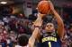 COLUMBUS, OH - FEBRUARY 11: Glenn Robinson III #1 of the Michigan Wolverines shoots over LaQuinton Ross #10 of the Ohio State Buckeyes in the first half on February 11, 2014 at Value City Arena in Columbus, Ohio. (Photo by Jamie Sabau/Getty Images)