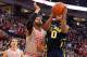 COLUMBUS, OH - FEBRUARY 11: Derrick Walton Jr. #10 of the Michigan Wolverines drives to the basket and shoots against Trey McDonald #55 of the Ohio State Buckeyes in the first half on February 11, 2014 at Value City Arena in Columbus, Ohio. (Photo by Ja