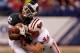 INDIANAPOLIS, IN - DECEMBER 03: Keshawn Martin #82 of the Michigan State Spartans loses his helmet as he is hit by Chris Borland #44 of the Wisconsin Badgers during the third quarter of the Big 10 Conference Championship Game at Lucas Oil Stadium on Dece