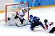 SOCHI, RUSSIA - FEBRUARY 12: Jenni Hiirikoski #6 of Finland scores the game winning goal in overtime to against Florence Schelling #41 of Switzerland to defeat Finland 4 to 3 in the Women's Ice Hockey Preliminary Round Group A game on day five of the Soc