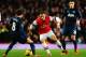 LONDON, ENGLAND - FEBRUARY 12: Mesut Ozil (C) of Arsenal takes on Juan Mata (L) of Manchester United during the Barclays Premier League match between Arsenal and Manchester United at the Emirates Stadium on February 12, 2014 in London, England. (Photo b