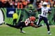 CINCINNATI, OH - JANUARY 05: Wide receiver Eddie Royal #11 of the San Diego Chargers runs with the ball as defensive end Michael Johnson #93 of the Cincinnati Bengals defends during a Wild Card Playoff game at Paul Brown Stadium on January 5, 2014 in Cin