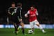 LONDON, ENGLAND - FEBRUARY 19: Santi Cazorla of Arsenal in action against Philipp Lahm of Bayern Muenchen during the UEFA Champions League round of 16 first leg match between Arsenal and Bayern Muenchen at Emirates Stadium on February 19, 2013 in London,