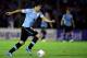 MONTEVIDEO, URUGUAY - NOVEMBER 20: Luis Suarez of Uruguay runs with the ball during leg 2 of the FIFA World Cup Qualifier match between Uruguay and Jordan at Centenario Stadium Stadium on November 20, 2013 in Montevideo, Uruguay. (Photo by Friedemann Vo