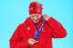 SOCHI, RUSSIA - FEBRUARY 14: Gold medalist Dario Cologna of Switzerland celebrates during the medal ceremony for the Cross Country Men's 15km Classic event on day 7 of the Sochi 2014 Winter Olympics at Medals Plaza on February 14, 2014 in Sochi, Russia.