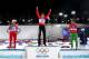 SOCHI, RUSSIA - FEBRUARY 14: (L-R) Silver medalist Selina Gasparin of Switzerland, gold medalist Darya Domracheva of Belarus and bronze medalist Nadezhda Skardino of Belarus celebrate on the podium during the flower ceremony for the Women's 15 km Individ