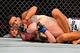 Feb 15, 2014; Jaragua do Sul, SC, Brazil; Charles Oliveira (red gloves) fights Andy Ogle (blue gloves) during UFC Fight Night Machida vs Mousasi at Arena Jaragua. Mandatory Credit: Jason Silva-USA TODAY Sports