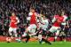 LONDON, ENGLAND - FEBRUARY 16: Lukas Podolski (C) of Arsenal gets his shot in under pressure to score his sides second goal during the FA Cup Fifth Round match between Arsenal and Liverpool at the Emirates Stadium on February 16, 2014 in London, England.