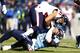 NASHVILLE, TN - DECEMBER 29: Jonathan Grimes #41 of the Houston Texans is tackled by Zach Brown #55 of the Tennessee Titans at LP Field on December 29, 2013 in Nashville, Tennessee. (Photo by Wesley Hitt/Getty Images)