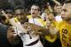 TEMPE, AZ - FEBRUARY 14: Jahii Carson #1 of the Arizona State Sun Devils is embraced by students in celebration of a 69-66 double overtime victory over the Arizona Wildcats during a college basketball game at Wells Fargo Arena on February 14, 2014 in Tem