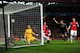 LONDON, ENGLAND - FEBRUARY 19: Wojciech Szczesny of Arsenal scrambles in vain to prevent the ball crossing the line as goalscorer Mario Mandzukic of Bayern Muenchen watches from inside the goal during the UEFA Champions League round of 16 first leg match