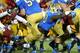 LOS ANGELES, CA - NOVEMBER 30: Myles Jack #30 of the UCLA Bruins dives into the end zone on a three yard touchdown carry in the first quarter against the USC Trojans at Los Angeles Coliseum on November 30, 2013 in Los Angeles, California. (Photo by Steph