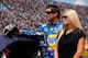 BROOKLYN, MI - AUGUST 19: Martin Truex Jr., driver of the #56 NAPA Auto Parts Toyota, stands with girlfriend Sherry Pollex during prerace ceremonies before the start of the NASCAR Sprint Cup Series Pure Michigan 400 at Michigan International Speedway on