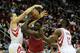 HOUSTON, TX - DECEMBER 18: Luol Deng #9 of the Chicago Bulls drives with the ball against Francisco Garcia #32 and James Harden #13 of the Houston Rockets during the game at Toyota Center on December 18, 2013 in Houston, Texas. NOTE TO USER: User express