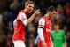MANCHESTER, ENGLAND - DECEMBER 14: Per Mertesacker of Arsenal has words with Mesut Oezil of Arsenal during the Barclays Premier League match between Manchester City and Arsenal at Etihad Stadium on December 14, 2013 in Manchester, England. (Photo by Ric