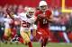 Dec 29, 2013; Phoenix, AZ, USA; Arizona Cardinals wide receiver Larry Fitzgerald (11) catches a pass under pressure from San Francisco 49ers cornerback Carlos Rogers (22) in the second quarter at University of Phoenix Stadium. Mandatory Credit: Mark J. Re