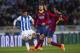 SAN SEBASTIAN, SPAIN - FEBRUARY 12: Sergio Busquets of FC Barcelona duels for the ball with Carlos Vela of Real Sociedad during the Copa del Rey Semi-Final first leg match between Real Sociedad and Barcelona at Estadio Anoeta on February 12, 2014 in San
