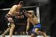 Feb 22, 2014; Las Vegas, NV, USA; Demian Maia (blue gloves) throws up his arm to block hits by Rory MacDonald (red gloves) during their UFC welterweight bout at Mandalay Bay. MacDonald won by way of a 29-28 decision. Mandatory Credit: Stephen R. Sylvanie-