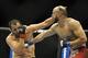 Feb 22, 2014; Las Vegas, NV, USA; Yosdenis Cedeno, punches Ernest Chavez during their lightweight bout at Mandalay Bay. Mandatory Credit: Stephen R. Sylvanie-USA TODAY Sports