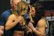 Feb 21, 2014; Las Vegas, NV, USA; Ronda Rousey (L) and Sara McMann (R) face off for photographs during the UFC 170 weigh-in at Mandalay Bay Events Center. Mandatory Credit: Stephen R. Sylvanie-USA TODAY Sports