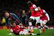 LONDON, ENGLAND - FEBRUARY 19: Mario Goetze of Bayern Muenchen clashes with Mathieu Flamini and Bacary Sagna of Arsenal during the UEFA Champions League Round of 16 first leg match between Arsenal and FC Bayern Muenchen at Emirates Stadium on February 19