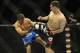Feb 22, 2014; Las Vegas, NV, USA; Demian Maia (blue gloves) tries to stop a kick to the side by Rory MacDonald (red gloves) during their UFC welterweight bout at Mandalay Bay. MacDonald won by way of a 29-28 decision. Mandatory Credit: Stephen R. Sylvani