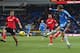 CARDIFF, WALES - FEBRUARY 22: Nikica Jelavic (R) of Hull City shoots as Juan Cala (L) of Cardiff City looks on during the Barclays Premier League match between Cardiff City and Hull City at the Cardiff City Stadium on February 22, 2014 in Cardiff, Wales.