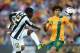 SYDNEY, AUSTRALIA - NOVEMBER 19: Joel Campbell of Costa Rica takes a shot at goal in front of Mile Jedinak of the Socceroos during the international friendly match between the Australian Socceroos and Costa Rica at Allianz Stadium on November 19, 2013 in