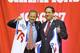 PHILADELPHIA - OCTOBER 18: Joshua J. Harris (L), senior managing director and founding partner of Apollo Global Management LLC, and Adam M. Aron (R), senior operating partner at Apollo Global Management ,hold up their new Philadelphia 76ers jerseys duri