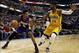 Feb 25, 2014; Indianapolis, IN, USA; Los Angeles Lakers guard Kent Bazemore (6) drives to the basket against Indiana Pacers forward Paul George (24) at Bankers Life Fieldhouse. Mandatory Credit: Brian Spurlock-USA TODAY Sports