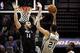 Jan 12, 2014; San Antonio, TX, USA; San Antonio Spurs forward Tim Duncan (21) shoots while being defended by Minnesota Timberwolves center Nikola Pekovic (14) during the second half at AT&T Center. Mandatory Credit: Soobum Im-USA TODAY Sports