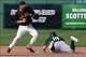 Feb 26, 2014; Scottsdale, AZ, USA; Oakland Athletics Billy Burns (19) safely slides into second base in front of San Francisco Giants Nick Noonan (21) at Scottsdale Stadium. Mandatory Credit: Lance Iversen-USA TODAY Sports