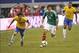Jun 3, 2012; Arlington, TX, USA; Mexico forward Javier Chicharito Hernandez (14) dribbles the ball past Brazil midfielder Oscar dos Santos Emboaba Junior (10) during the first half at Cowboys Stadium. Mandatory Credit: Jerome Miron-USA TODAY Sports
