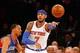 Jan 22, 2014; New York, NY, USA; New York Knicks small forward Carmelo Anthony (7) passes the ball back outside as he is guarded by Philadelphia 76ers small forward Evan Turner (12) at Madison Square Garden. Mandatory Credit: Jim O'Connor-USA TODAY Sport