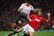 MANCHESTER, ENGLAND - SEPTEMBER 25: Jonny Evans of Manchester United tackles Luis Suarez of Liverpool during the Capital One Cup Third Round match betwen Manchester United and Liverpool at Old Trafford on September 25, 2013 in Manchester, England. (Phot