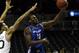NEW YORK, NY - DECEMBER 21: Javon McCrea #12 of the Buffalo Bulls drives to the basket past Ashton Pankey #30 of the Manhattan Jaspers during the Brooklyn Hoops Holiday Invitational at Barclays Center on December 21, 2013 in the Brooklyn borough of New Y