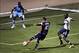 Feb 22, 2014; Tucson, AZ, USA; New England Revolution forward Teal Bunbury (10) scores on goal as Chivas USA goalkeeper Larry Jackson (22) defends during the first half at Kino Sports Complex. Mandatory Credit: Casey Sapio-USA TODAY Sports