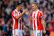 STOKE ON TRENT, ENGLAND - MARCH 01: Geoff Cameron of Stoke City celebrates with team-mate Ryan Shawcross at the end of the Barclays Pemier League match between Stoke City and Arsenal at the Britannia Stadium on March 1, 2014 in Stoke on Trent, England.