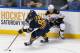 BUFFALO, NY - FEBRUARY 26: Marcus Foligno #82 of the Buffalo Sabres works to move the puck out of his zone against Kevan Miller #86 of the Boston Bruins at First Niagara Center on February 26, 2014 in Buffalo, New York. (Photo by Rick Stewart/Getty Imag