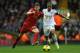 LIVERPOOL, ENGLAND - FEBRUARY 23: Jon Flanagan of Liverpool battles with Wayne Routledge of Swansea City during the Barclays Premier League match between Liverpool and Swansea City at Anfield on February 23, 2014 in Liverpool, England. (Photo by Clive B